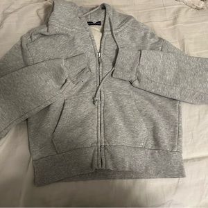 Brandy Melville cropped zip-up sweatshirt.